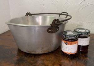 A jam pan with two pots of redcurrant jelly