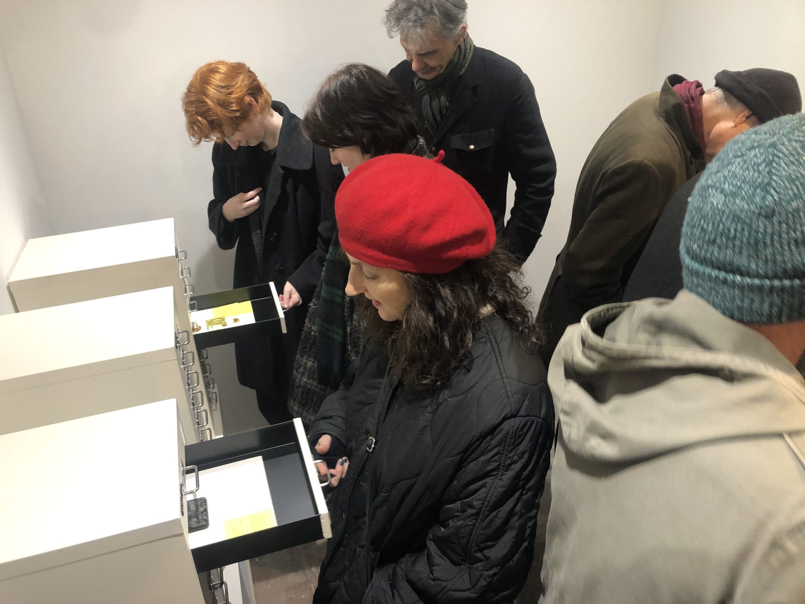 People looking through the drawers to see artefacts in the Museum of Totterdown