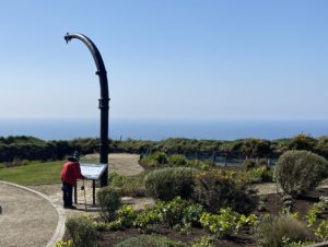 DP LIndegaard reading a poster board at the Lusitania Memorial Garden in Cork.