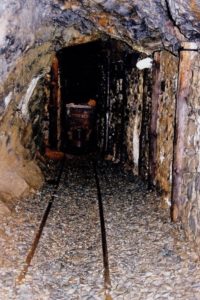 Inside the adit to the Great Laxey Mine. showing rails going into a tunnel
