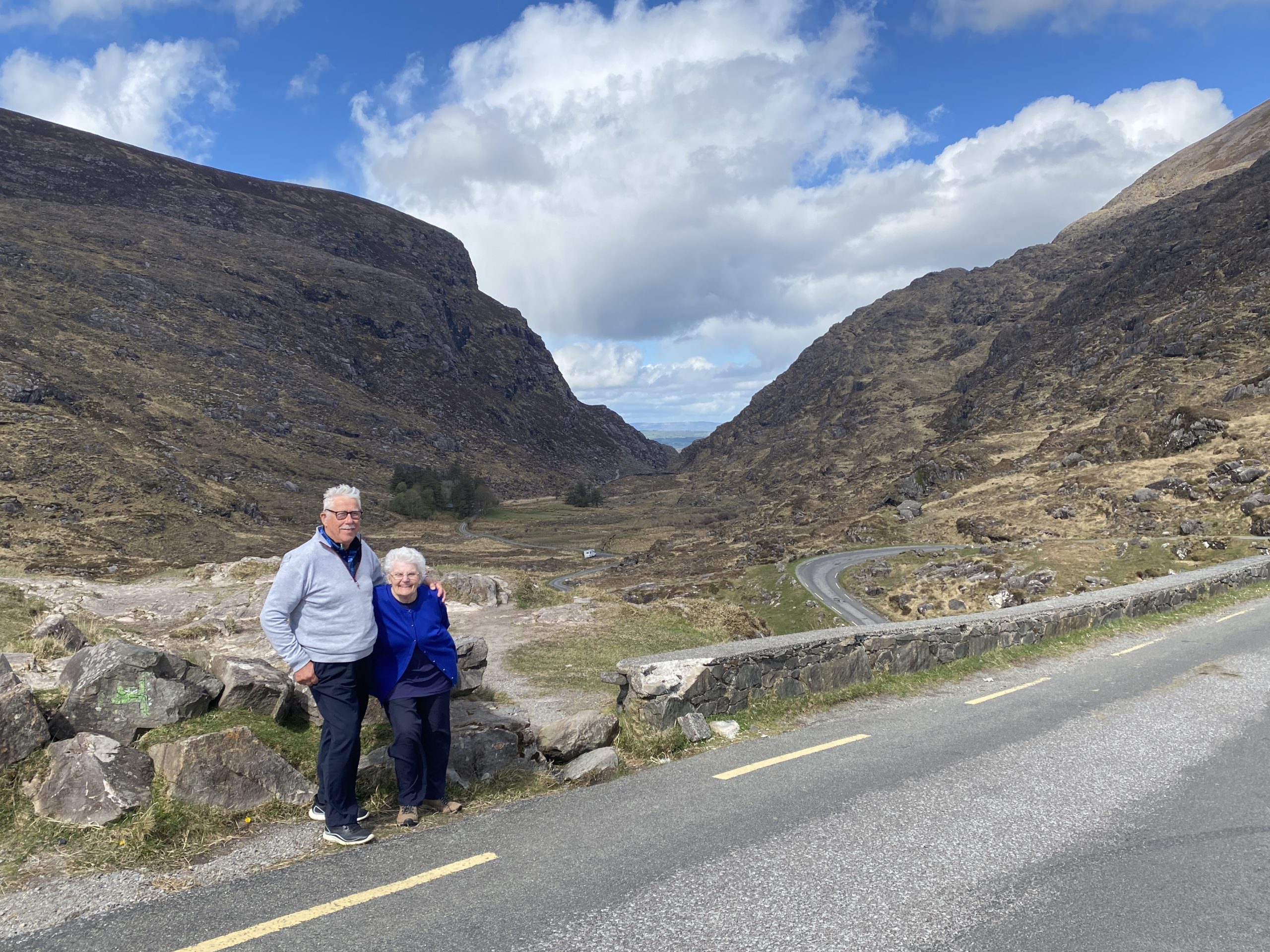 Norman (aka George) and Doreen Lindegaard dtanding arm in arm with a view of the Gap of Dunlow