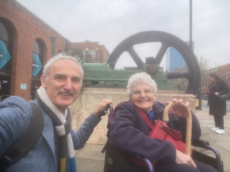 DP Lindegaard in a wheelchair with her son Kevin Lindegaard outside the Manchester Industrial Museum