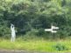 Somerset metal coal mining silhouette of a 2m high miner with raised pitchfork at Newton St Loe next to a signpost showing directions to Bristol and Bath.